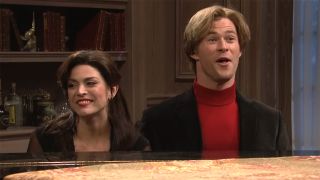 Chris Hemsworth and Cecily Strong sing at piano in SNL skit.