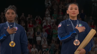 Simone Biles and Suni Lee with medals at 2024 Olympics